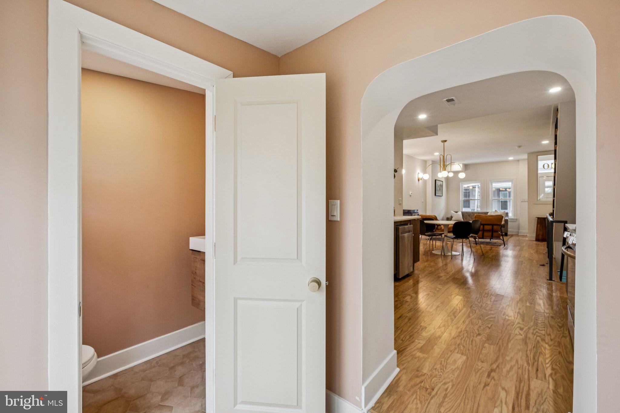 3010 Redner Street Philadelphia, PA 19121 - Photo 9 of 27 a view of a hallway with wooden floor a glass door with a kitchen space