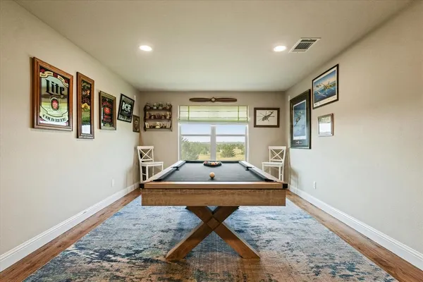a living room with couch cabinet and window