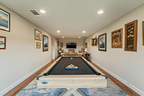 a room with pool table and furniture