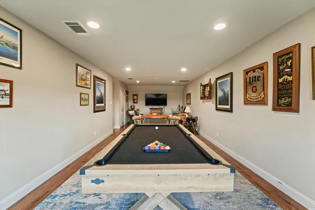 a room with pool table and furniture