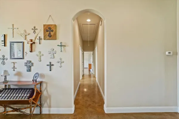 a view of a hallway to a livingroom with furniture