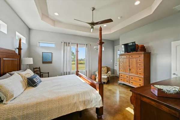 a bedroom with a bed dresser and a window