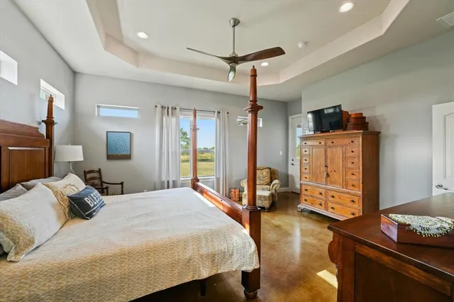 a bedroom with a bed dresser and a window