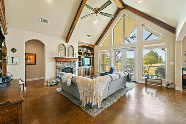 a spacious bedroom with bed and a large window