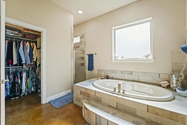 a bathroom with a tub and a window