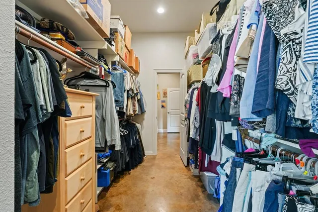 a view of walk in closet with clothes