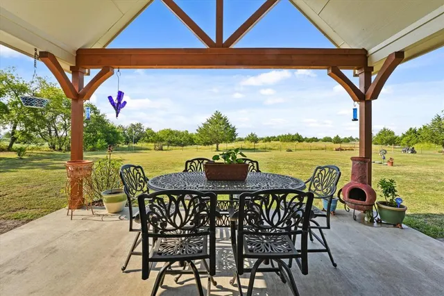 a view of a table and chairs in the patio