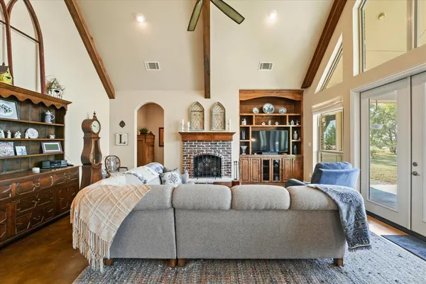a large bedroom with a large bed and a fireplace