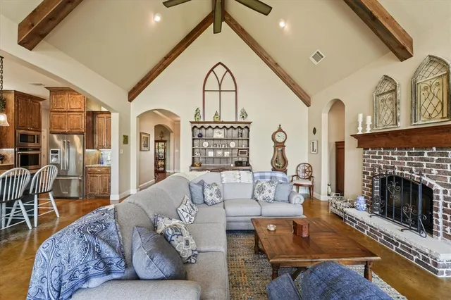 a living room with furniture a fireplace and wooden floor