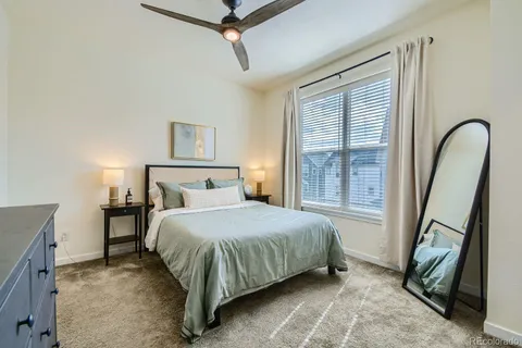a bedroom with a bed next to a window