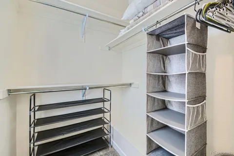 a view of walk in closet with empty racks