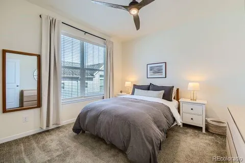 a bedroom with a bed and large window
