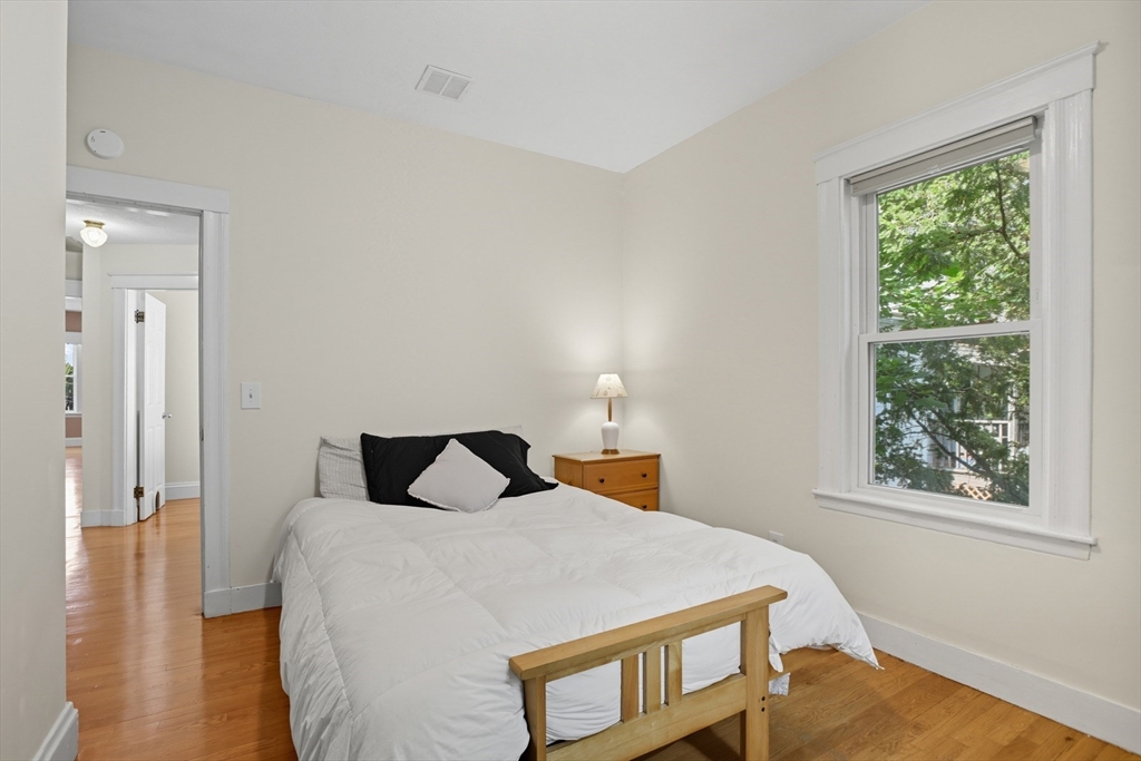 415-417 Washington Street Winchester, MA 01890 - Photo 20 of 41 a bedroom with a bed and wooden floor