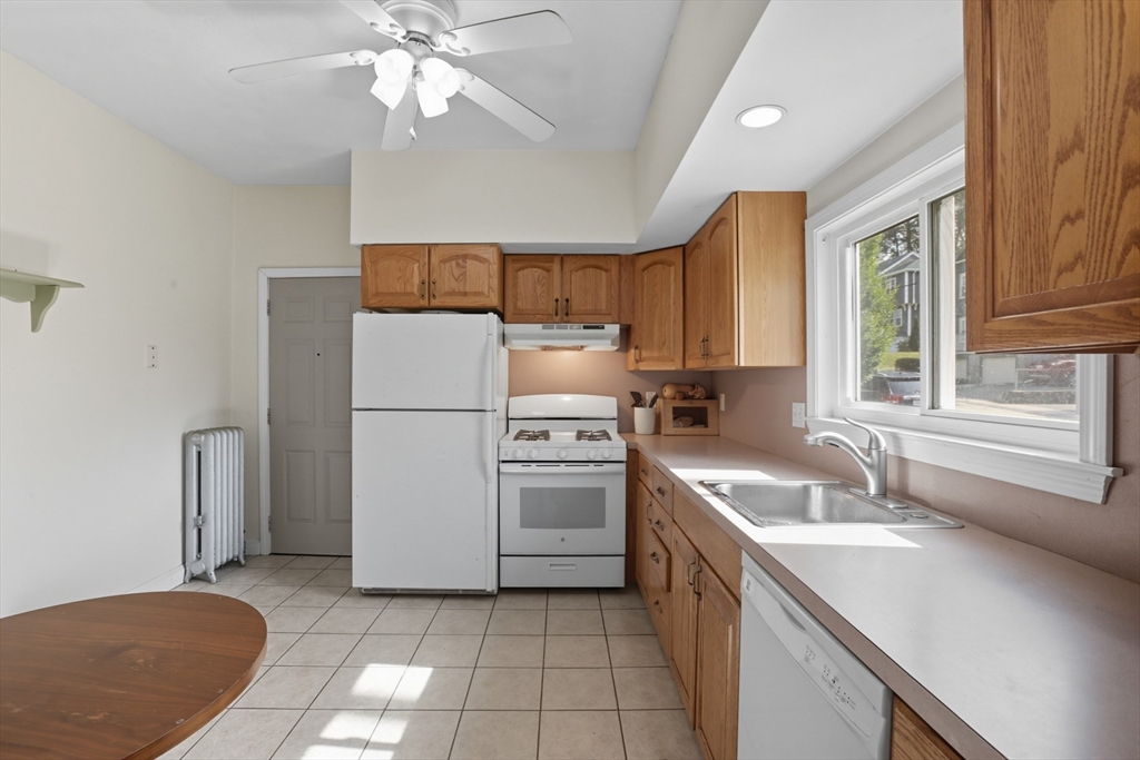 415-417 Washington Street Winchester, MA 01890 - Photo 28 of 41 a kitchen with a sink a oven a refrigerator a stove and a window