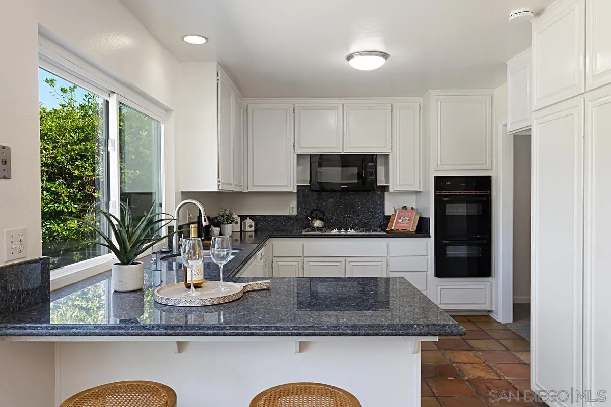 4520 Trieste Drive Carlsbad, CA 92010 - Photo 11 of 27 a kitchen with sink a refrigerator and microwave