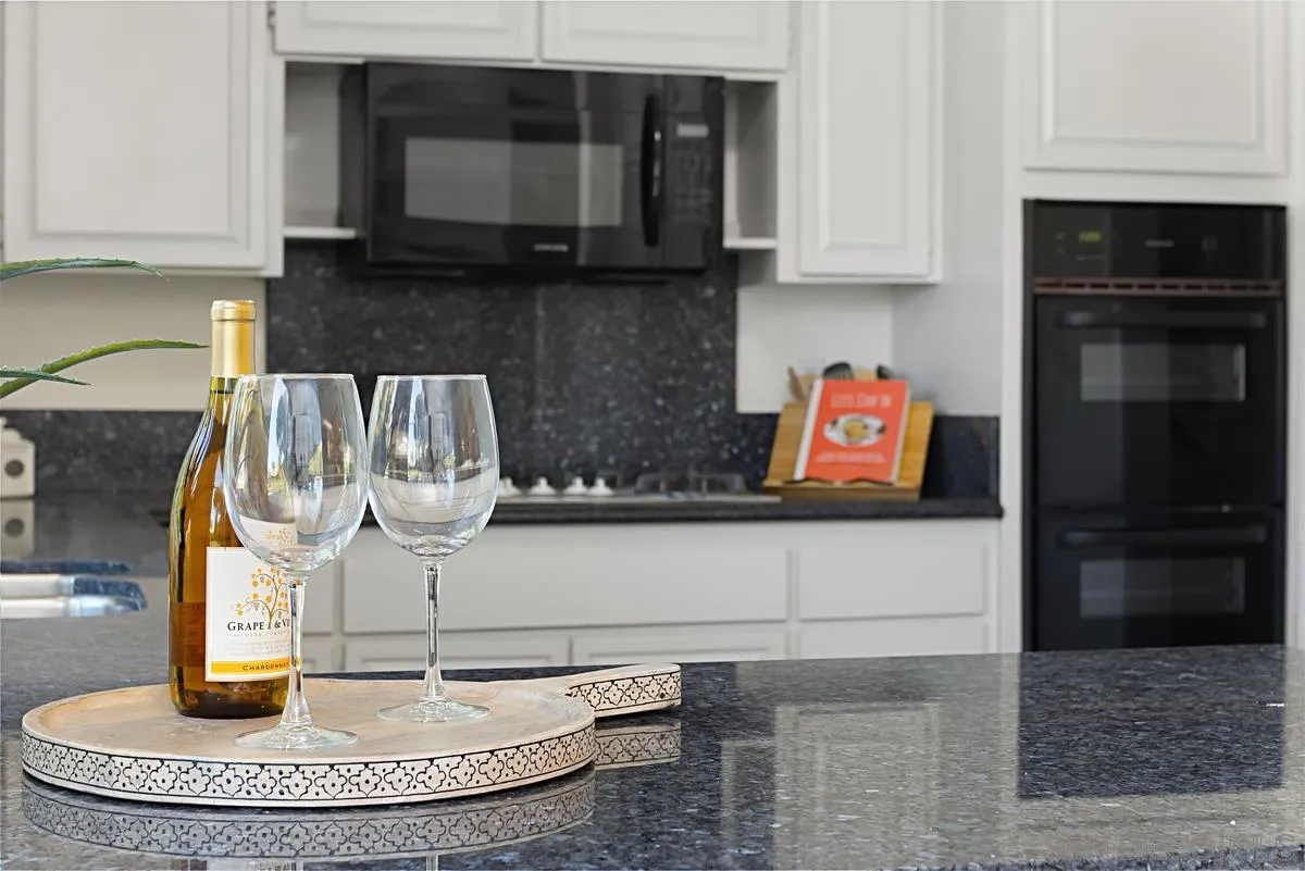 4520 Trieste Drive Carlsbad, CA 92010 - Photo 15 of 27 a kitchen with a stove and a microwave