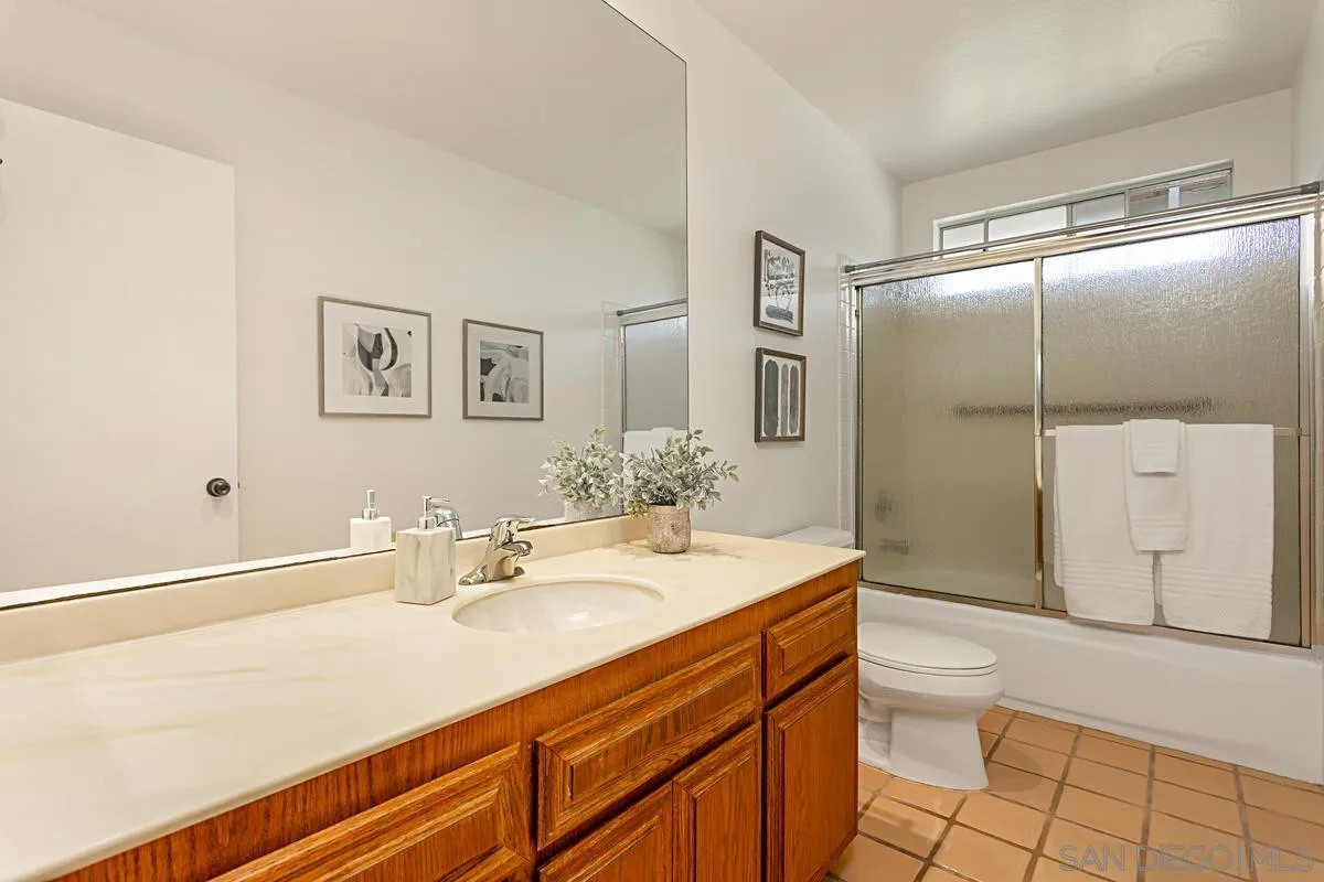 4520 Trieste Drive Carlsbad, CA 92010 - Photo 17 of 27 a bathroom with a sink a toilet and large mirror