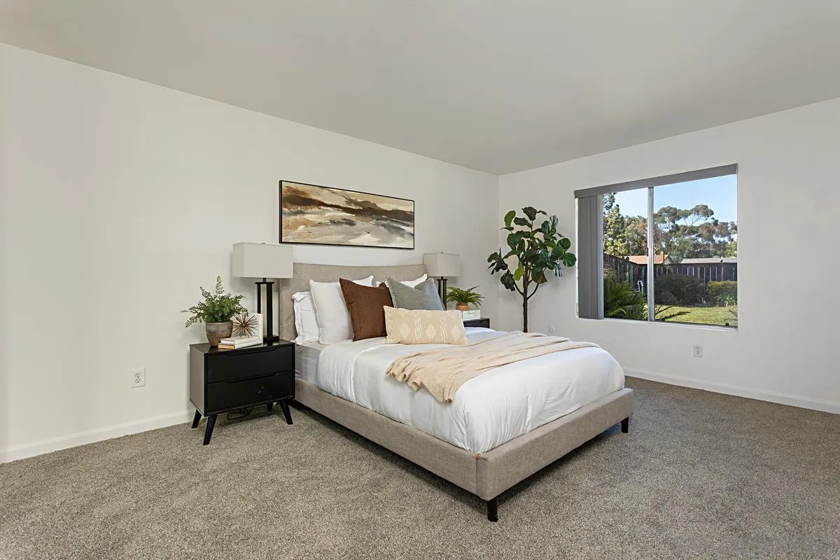 4520 Trieste Drive Carlsbad, CA 92010 - Photo 19 of 27 a large bed sitting in a bedroom next to a window