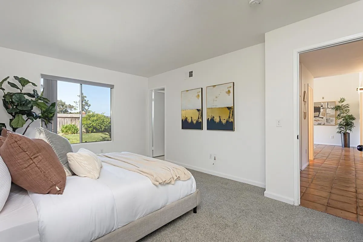 4520 Trieste Drive Carlsbad, CA 92010 - Photo 20 of 27 a bedroom with a bed and a painting on the wall