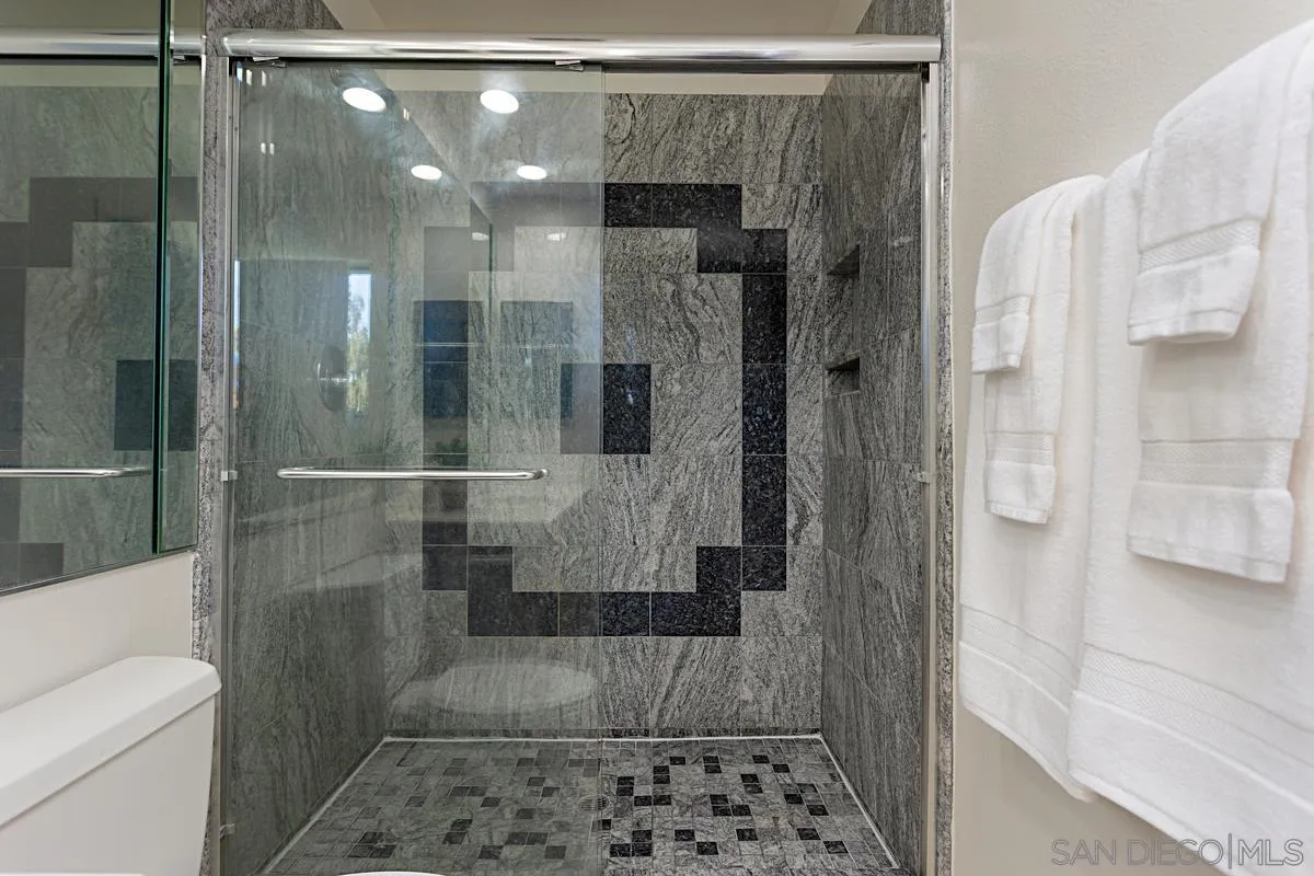 4520 Trieste Drive Carlsbad, CA 92010 - Photo 23 of 27 a bathroom with a shower and a sink