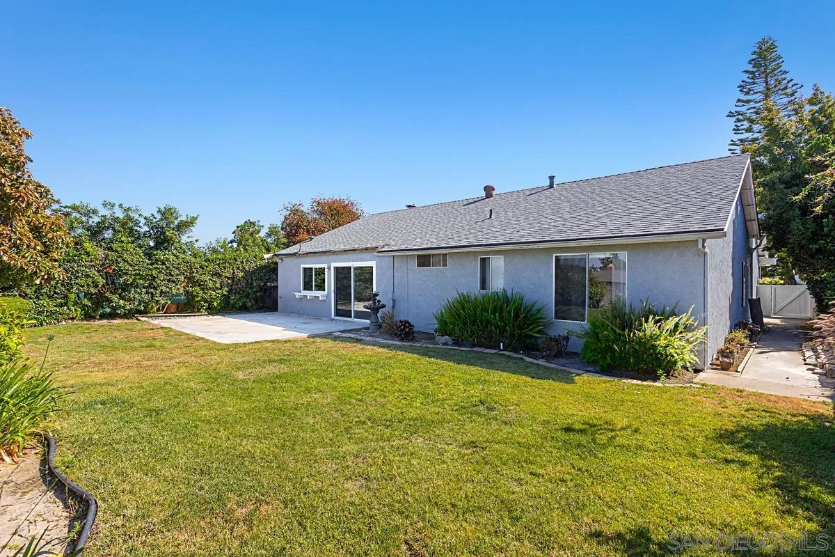4520 Trieste Drive Carlsbad, CA 92010 - Photo 25 of 27 a front view of a house with yard and green space