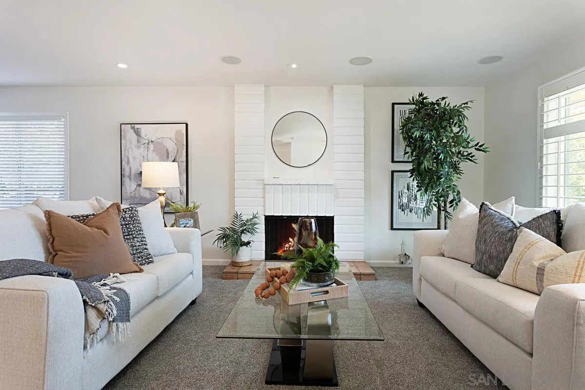 4520 Trieste Drive Carlsbad, CA 92010 - Photo 4 of 27 a living room with furniture a fireplace and a large window
