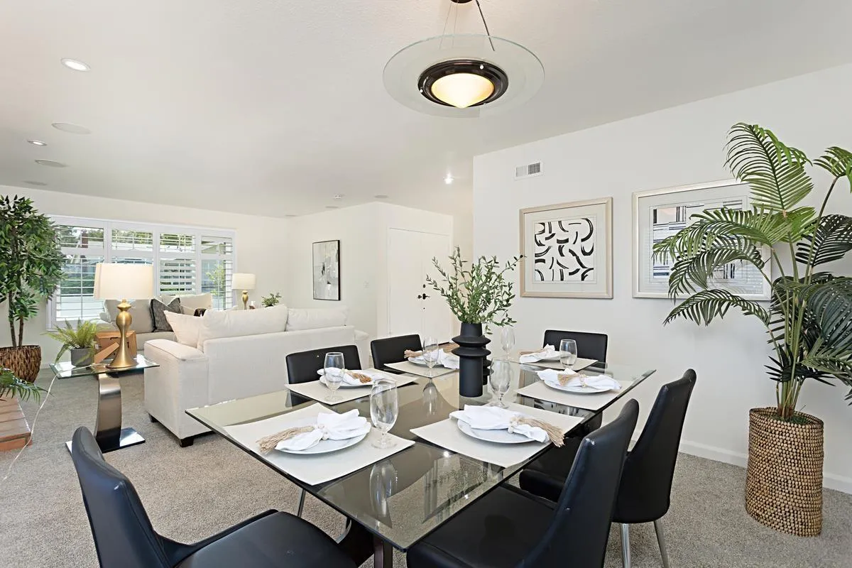 4520 Trieste Drive Carlsbad, CA 92010 - Photo 6 of 27 a dining room with furniture a rug and a potted plant