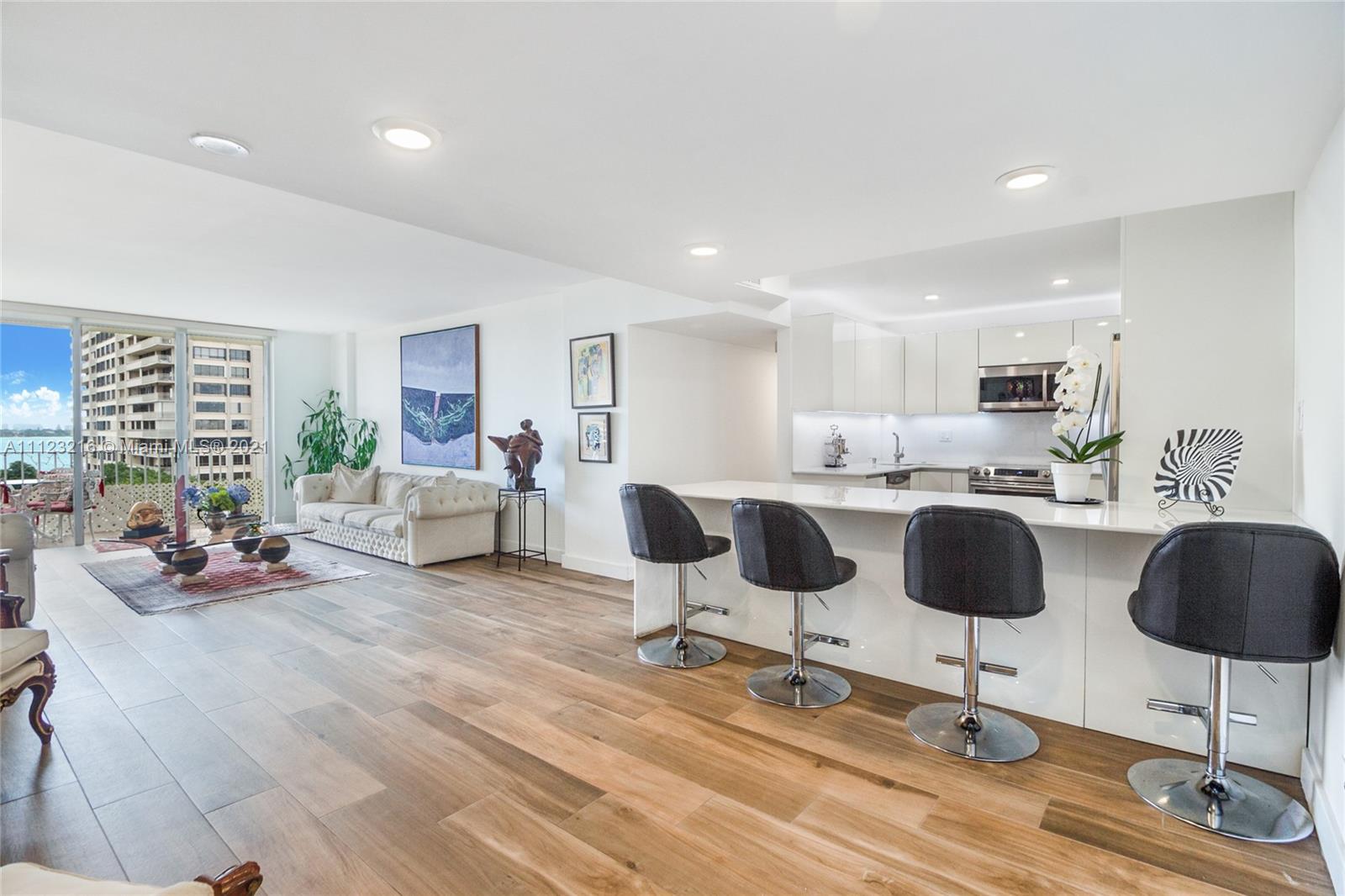 11111 Biscayne Boulevard, Unit 7C Miami, FL 33181 - Photo 1 of 18 a living room with furniture and kitchen view