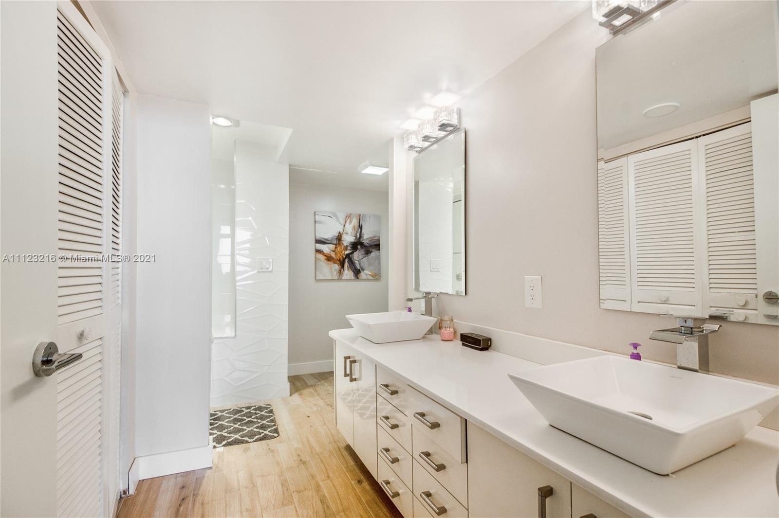 11111 Biscayne Boulevard, Unit 7C Miami, FL 33181 - Photo 11 of 18 a bathroom with a sink double vanity and a mirror