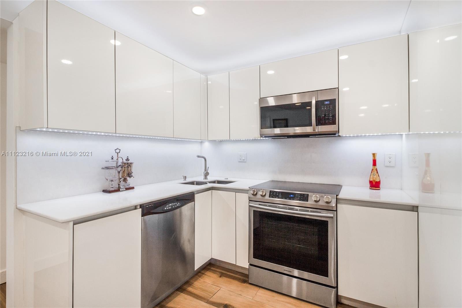 11111 Biscayne Boulevard, Unit 7C Miami, FL 33181 - Photo 3 of 18 a kitchen with stainless steel appliances granite countertop a sink stove and microwave