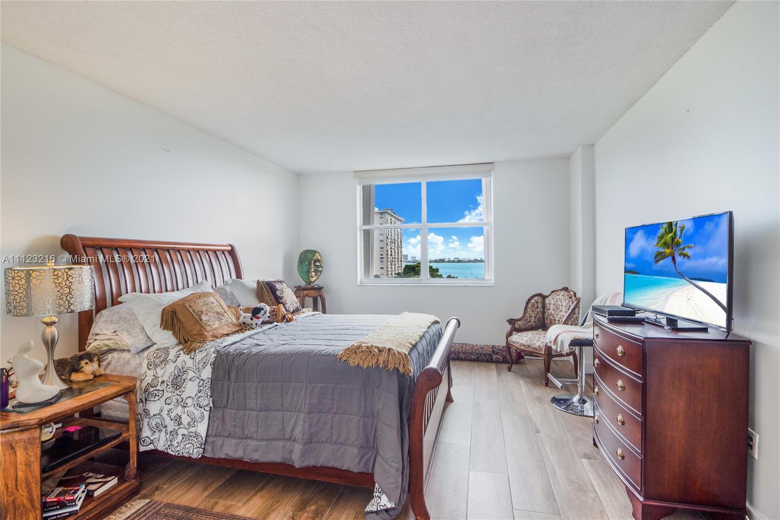 11111 Biscayne Boulevard, Unit 7C Miami, FL 33181 - Photo 6 of 18 a bedroom with bed and a window
