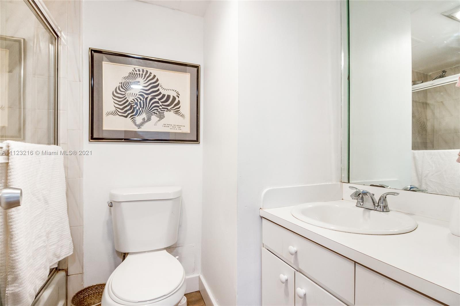 11111 Biscayne Boulevard, Unit 7C Miami, FL 33181 - Photo 7 of 18 a bathroom with a toilet sink and vanity