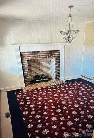 a view of empty room with window and fireplace