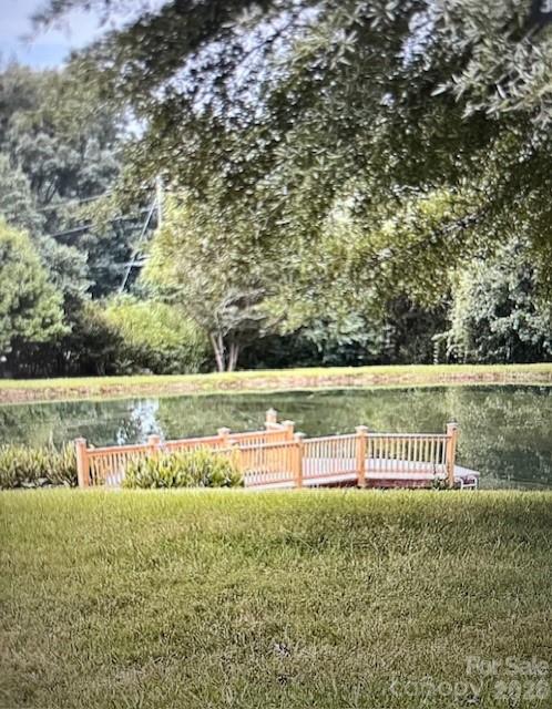 40659 Ridenhour Road Richfield, NC 28137 - Photo 7 of 24 a view of a lake with a yard and large trees