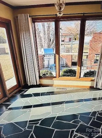 a view of a room with wooden floor and windows
