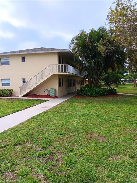 3325 Airport Road North, Unit H7 Naples, FL 34105 - Photo 1 of 15 a view of a house with a yard