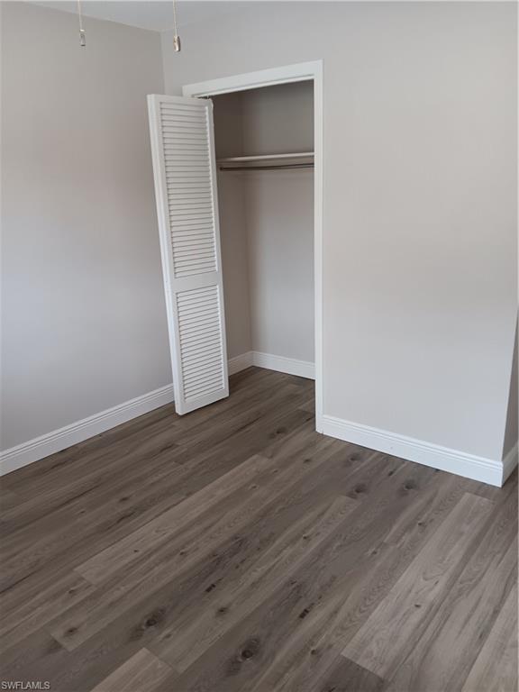 3325 Airport Road North, Unit H7 Naples, FL 34105 - Photo 11 of 15 an empty room with wooden floor and closet