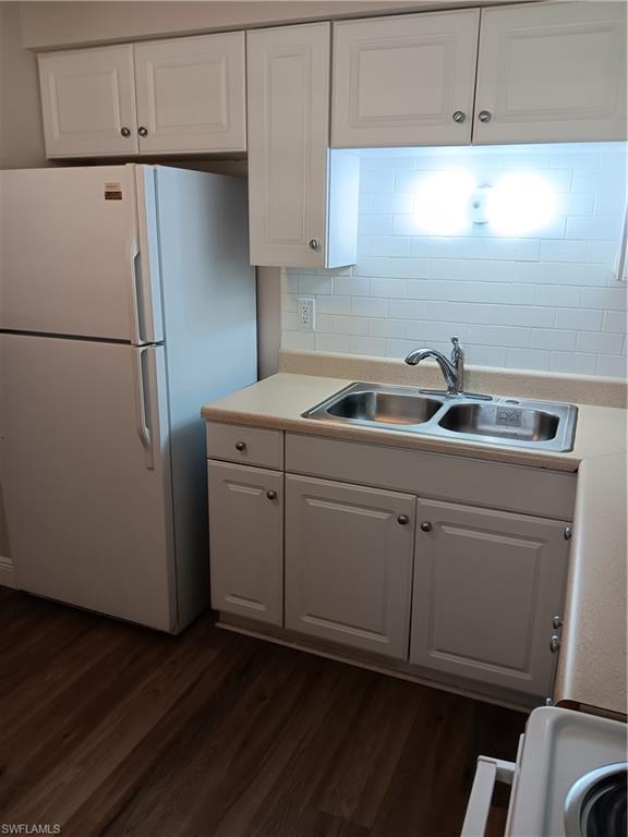 3325 Airport Road North, Unit H7 Naples, FL 34105 - Photo 5 of 15 a kitchen with a refrigerator sink and cabinets
