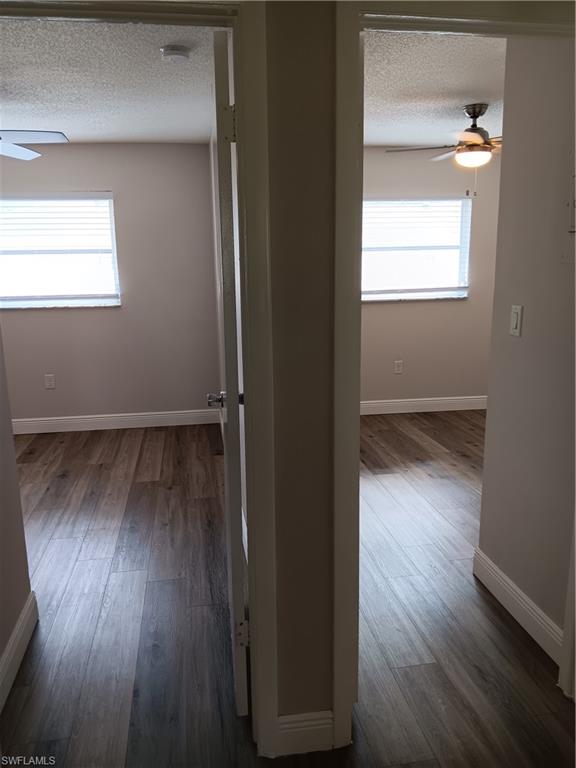 3325 Airport Road North, Unit H7 Naples, FL 34105 - Photo 8 of 15 an empty room with wooden floor closet and windows