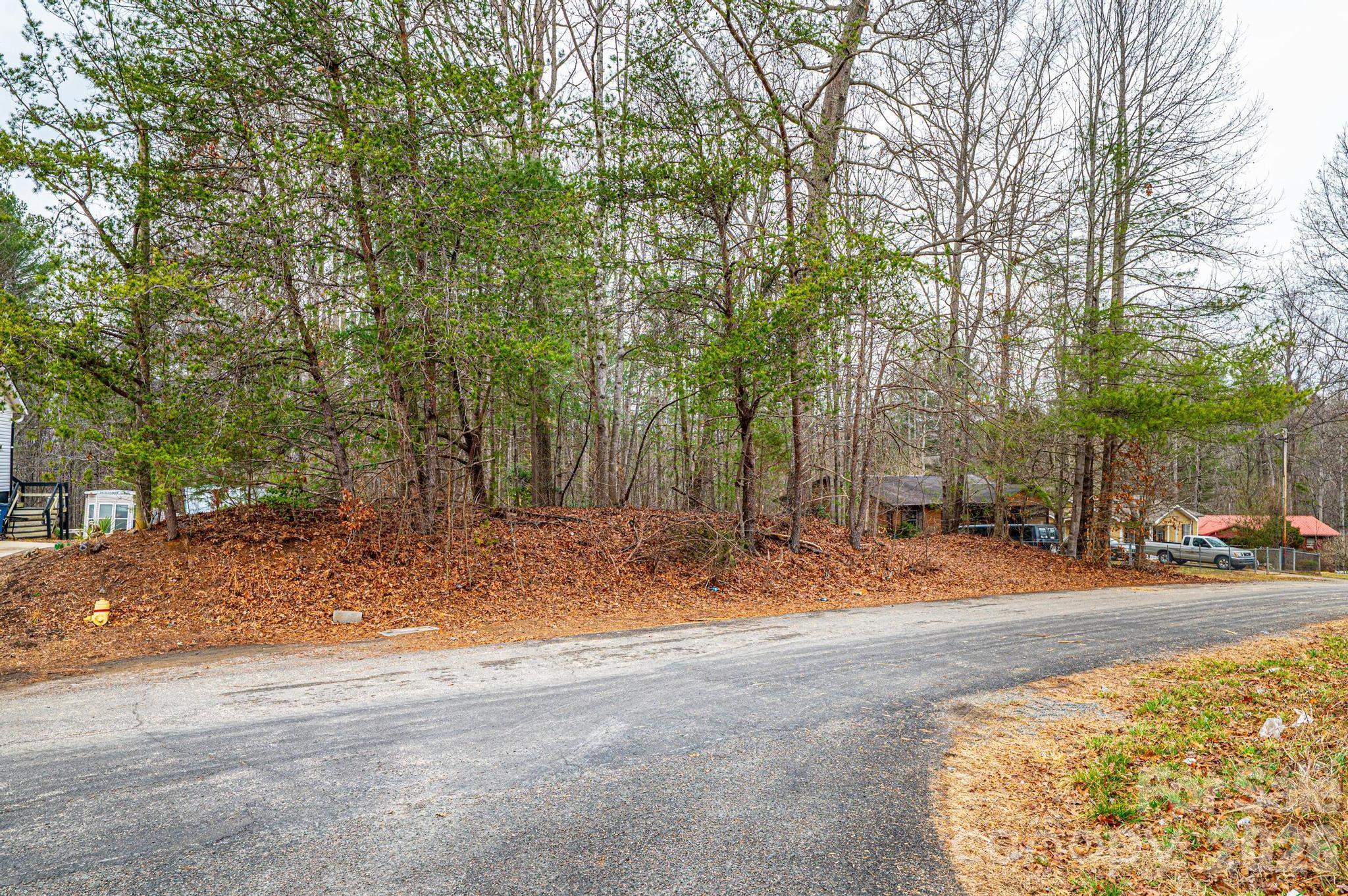 Tba Staircase Road Lenoir, NC 28645 - Photo 5 of 10 a backyard of a house with large trees and outdoor seating