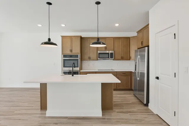 a kitchen with kitchen island a counter top space appliances and cabinets