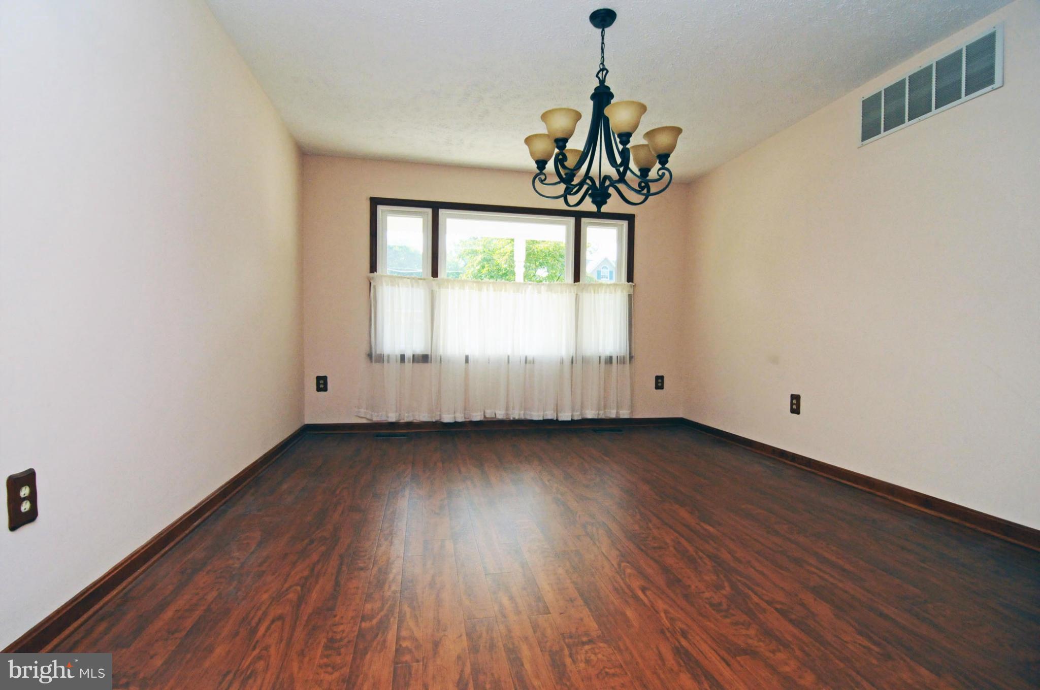 7881 Walnut Grove Road Severn, MD 21144 - Photo 5 of 21 a view of a room with wooden floor and window