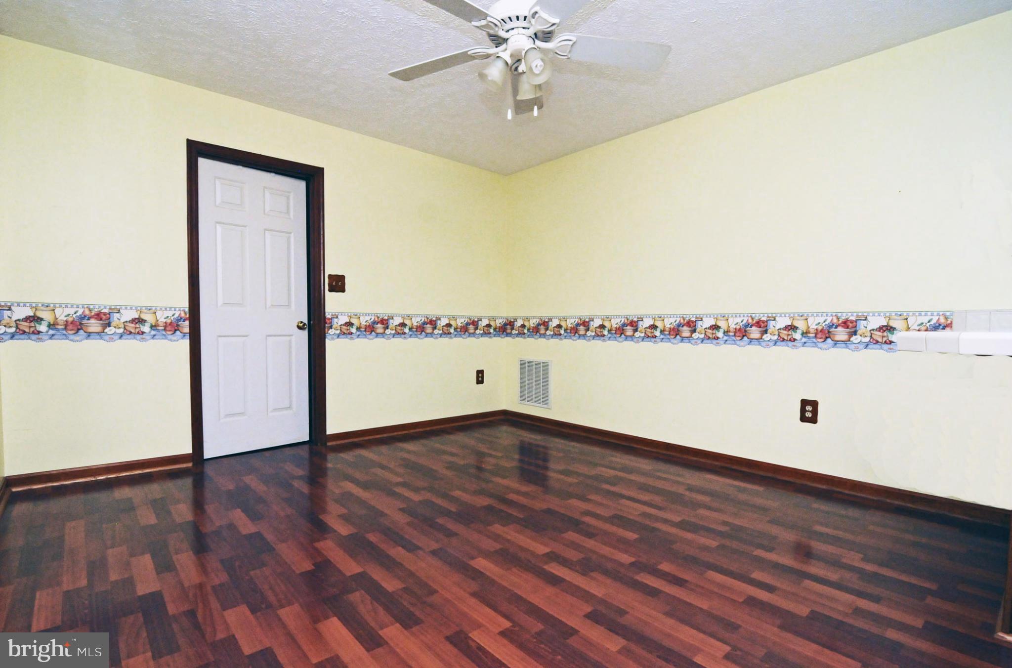7881 Walnut Grove Road Severn, MD 21144 - Photo 8 of 21 an empty room with wooden floor and fan