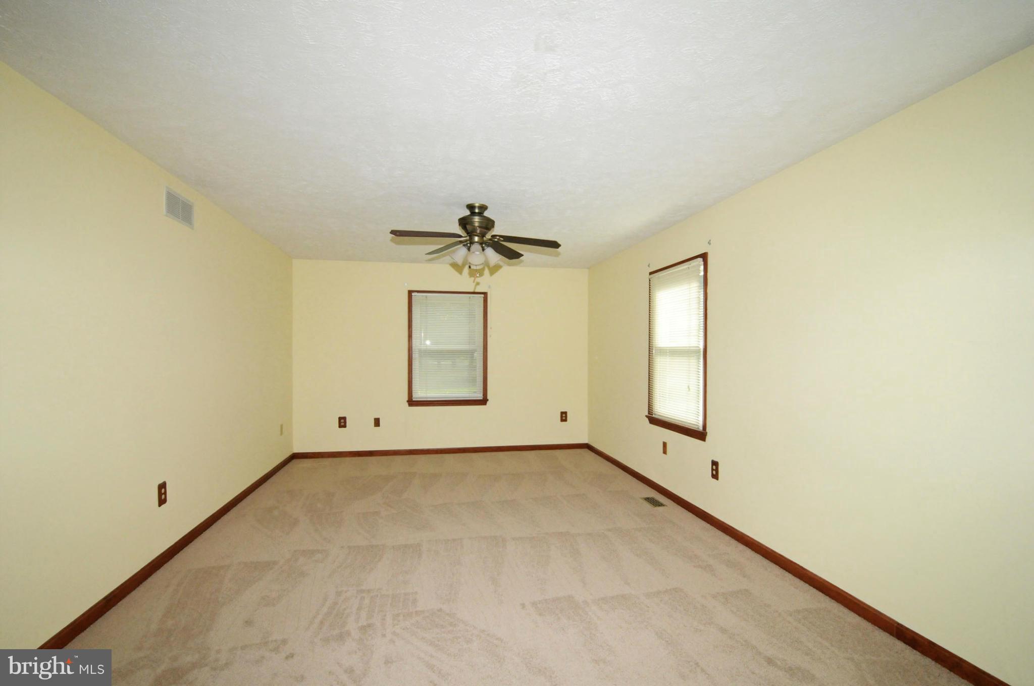 7881 Walnut Grove Road Severn, MD 21144 - Photo 9 of 21 an empty room with windows and fan