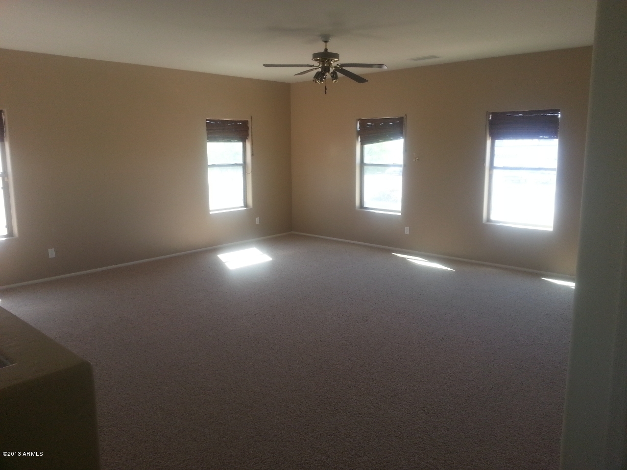 44395 Cypress Lane Maricopa, AZ 85138 - Photo 13 of 20 an empty room with windows and fan