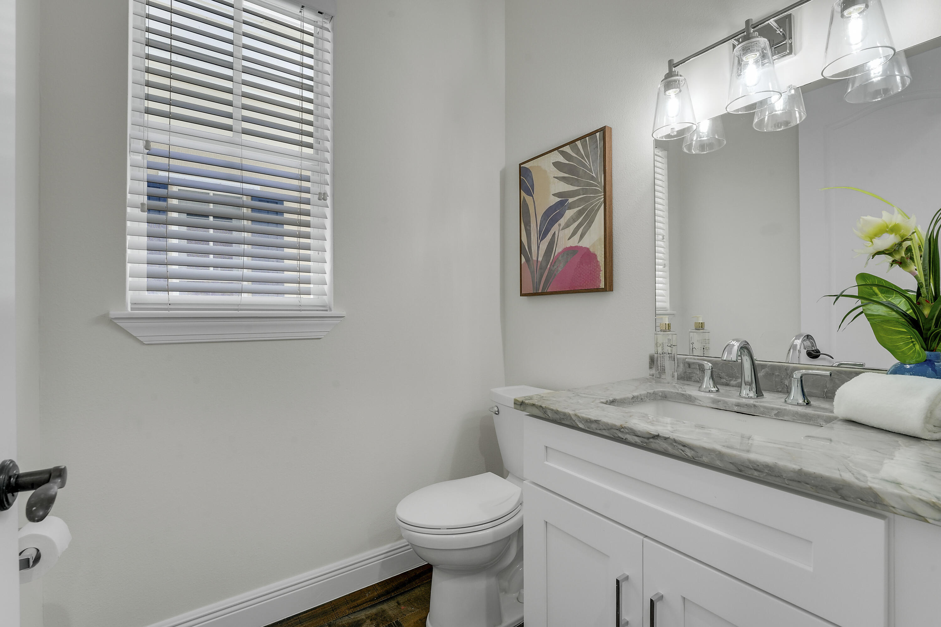 112 Spikerush Road Jupiter, FL 33458 - Photo 22 of 49 a bathroom with a granite countertop toilet sink and mirror