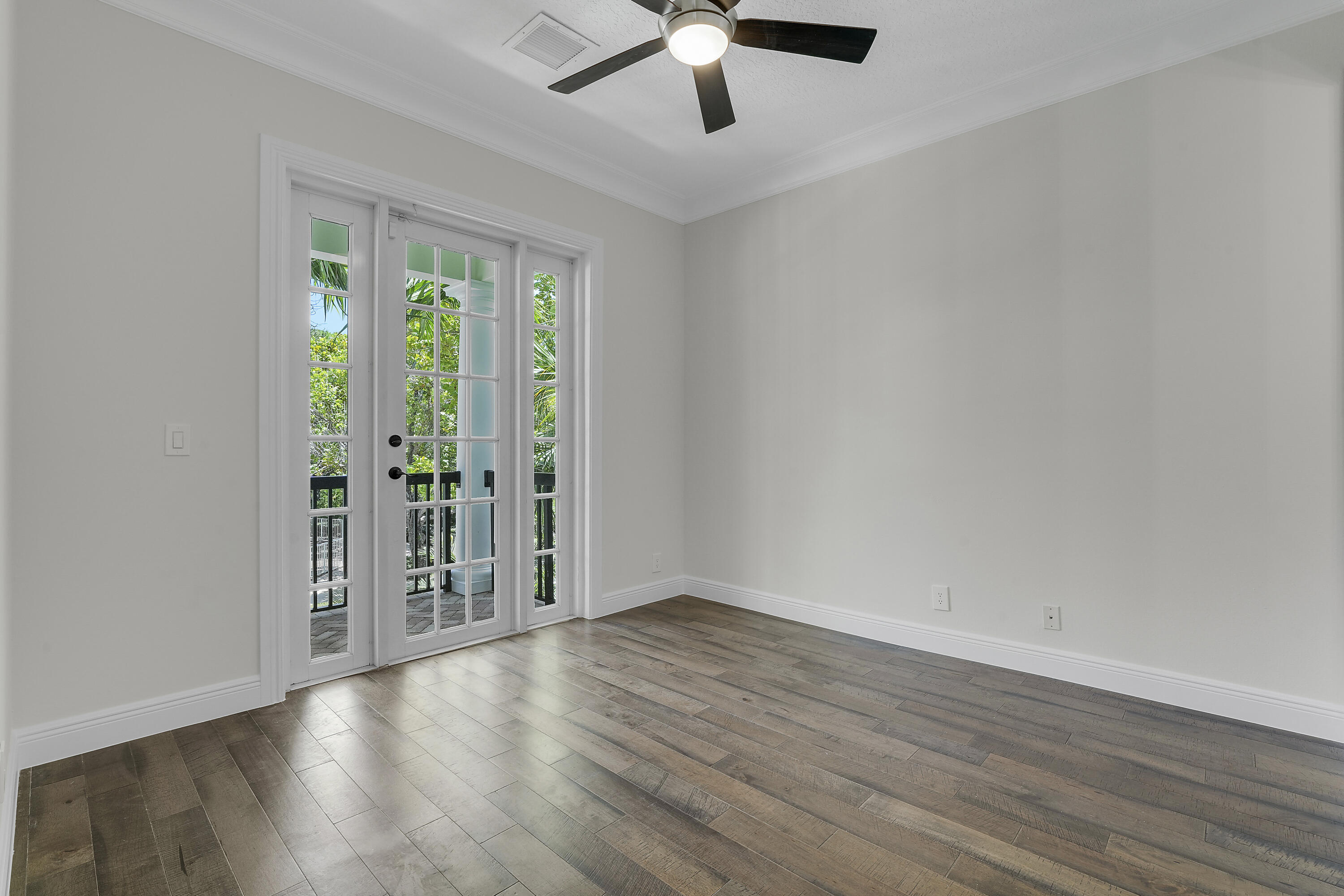 112 Spikerush Road Jupiter, FL 33458 - Photo 35 of 49 wooden floor in an empty room with a window
