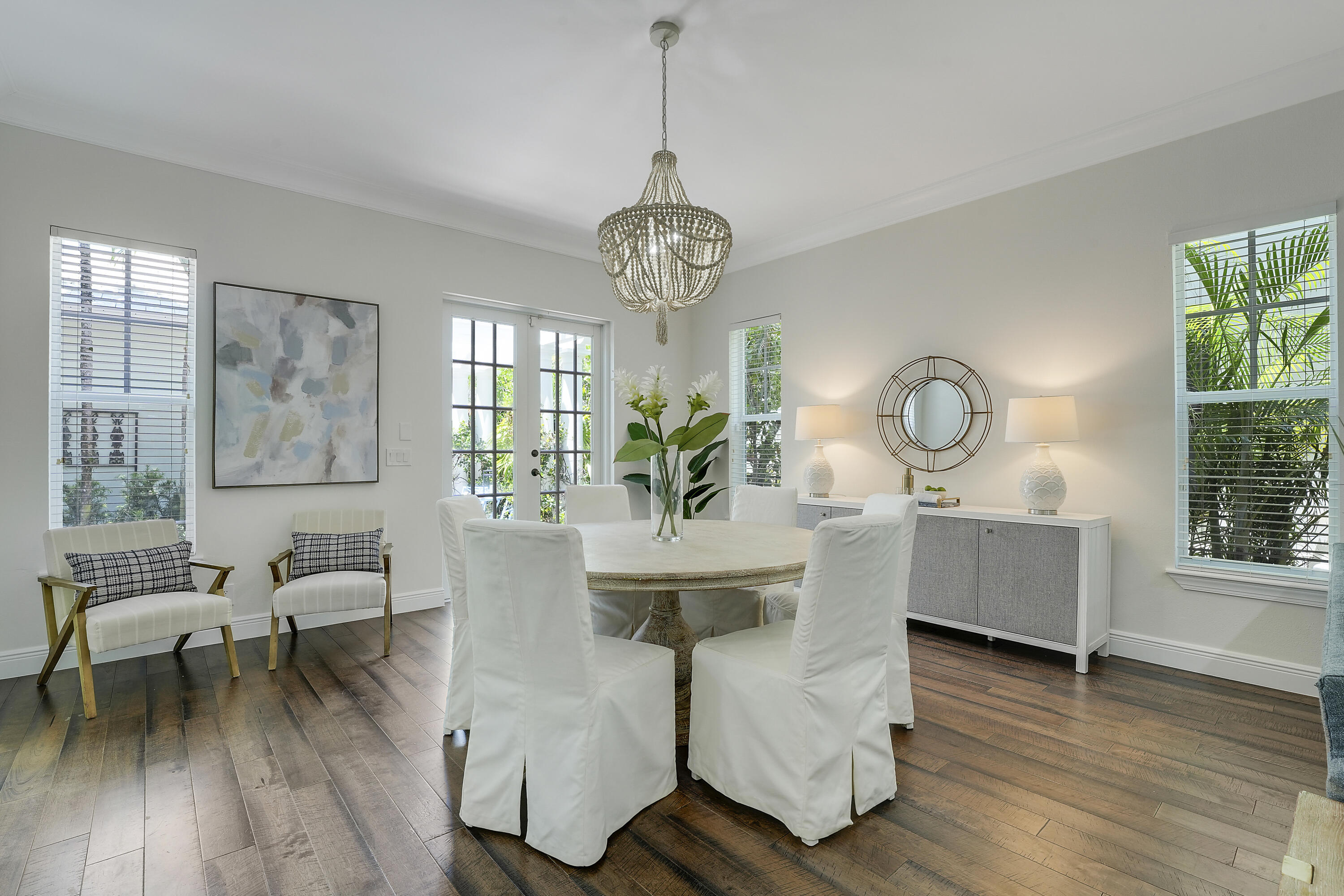 112 Spikerush Road Jupiter, FL 33458 - Photo 10 of 49 a living room with couches a table and a large mirror with wooden floor