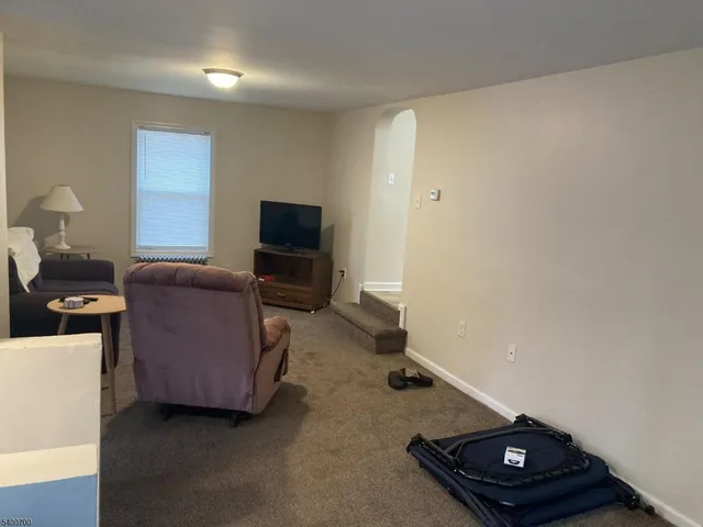 a room with furniture and a flat screen tv