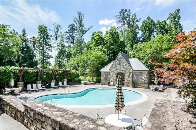 a swimming pool with outdoor seating and yard